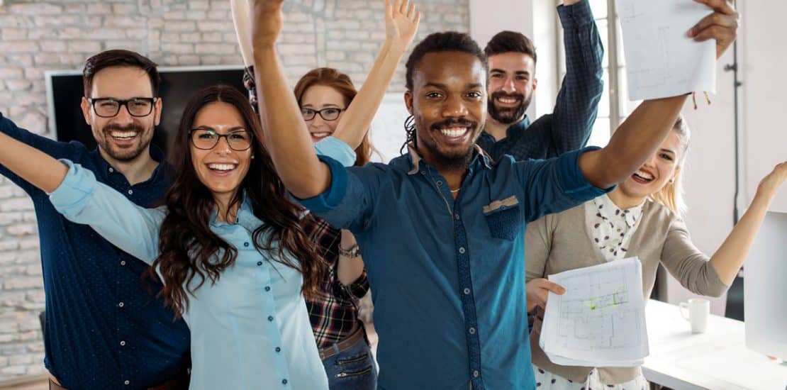 Happy successful company staff in office